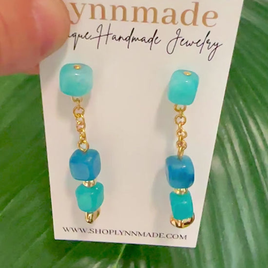 Coastal Gemstone Earrings Dive into summer with the Coastal Gemstone Earrings. Handcrafted with natural Apatite, Amazonian, Vibrant Fuchsia Jade, and lively Peridot green stones, these earrings capture the essence of the sea and sun. Their vibrant hues and elegant design make them the perfect accessory for your summer vacation, adding a touch of coastal charm to any outfit. Embrace the season's beauty with these stunning statement pieces.